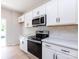 Kitchen with stainless steel appliances, white cabinetry, and light countertop at 2021 Endeavor Run, Charlotte, NC 28269