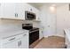 Stylish kitchen features stainless steel appliances and white cabinets at 2021 Endeavor Run, Charlotte, NC 28269