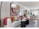 Stylish living room with a white sofa, colorful artwork, and a dining area in the background at 2021 Endeavor Run, Charlotte, NC 28269