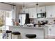 Modern kitchen with stainless steel appliances, white countertops, and pendant lighting at 2028 Endeavor Run, Charlotte, NC 28269