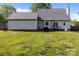 Well-maintained backyard featuring a lush lawn, patio with grill, and gray siding at 230 Castle Keep Rd, Salisbury, NC 28146