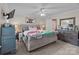 Comfortable bedroom featuring a tufted headboard, ceiling fan, and neutral decor at 230 Castle Keep Rd, Salisbury, NC 28146