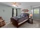 Cozy bedroom with a ceiling fan, natural light, and a comfortable queen bed at 230 Castle Keep Rd, Salisbury, NC 28146
