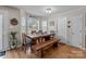 Bright dining area features a wood table, bench seating, and a view of the backyard at 230 Castle Keep Rd, Salisbury, NC 28146