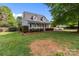 Well-maintained home with a manicured lawn, mature trees, and inviting front porch at 230 Castle Keep Rd, Salisbury, NC 28146