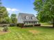 Inviting two-story home features a covered front porch, manicured lawn, and mature landscaping at 230 Castle Keep Rd, Salisbury, NC 28146