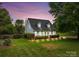Charming home with a covered front porch, manicured landscaping, and well-lit front yard at 230 Castle Keep Rd, Salisbury, NC 28146