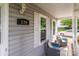 Charming front porch adorned with cozy wicker seating, and bright window shutters at 230 Castle Keep Rd, Salisbury, NC 28146