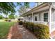 Long front porch with decorative bushes, and walkway leading up to the door at 230 Castle Keep Rd, Salisbury, NC 28146