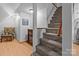 Hallway features carpeted stairs, chair and fireplace, with hardwood flooring at 230 Castle Keep Rd, Salisbury, NC 28146