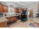 Kitchen features dark appliances, granite countertops, tiled floors and backsplash, and dark wood cabinetry at 230 Castle Keep Rd, Salisbury, NC 28146