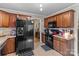 Spacious kitchen featuring granite countertops, black appliances, and dark wood cabinetry at 230 Castle Keep Rd, Salisbury, NC 28146