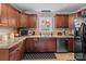 Well-lit kitchen featuring granite countertops, stainless steel appliances, and dark wood cabinetry at 230 Castle Keep Rd, Salisbury, NC 28146