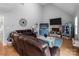 Cozy living room with stone fireplace, vaulted ceiling, and comfortable seating arrangement at 230 Castle Keep Rd, Salisbury, NC 28146