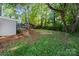 Lush backyard featuring mature trees, offering a private outdoor space at 300 N Ervin Ave, Newton, NC 28658