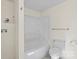 White bathroom with a tub and shower combo and a modern toilet at 300 N Ervin Ave, Newton, NC 28658