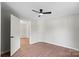 Bedroom showcasing hardwood floors, neutral walls, and ample closet space at 300 N Ervin Ave, Newton, NC 28658