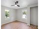 A cozy bedroom with hardwood floors, neutral color scheme, and ample natural light at 300 N Ervin Ave, Newton, NC 28658