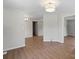 Bedroom showcasing hardwood floors, white walls, and ample closet space at 300 N Ervin Ave, Newton, NC 28658