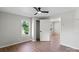 Bright bedroom features a ceiling fan, wood-look floors and a window with views of the outside at 300 N Ervin Ave, Newton, NC 28658