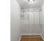 Bright closet with shelves, bars, and wooden trim on the floor at 300 N Ervin Ave, Newton, NC 28658