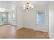 Bright dining room featuring wood floors, a modern chandelier, and natural light at 300 N Ervin Ave, Newton, NC 28658
