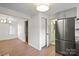 Spacious area with stainless steel refrigerator, hardwood floors, and bright lighting at 300 N Ervin Ave, Newton, NC 28658