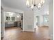 Open living space showcasing hardwood floors and a view of the updated kitchen at 300 N Ervin Ave, Newton, NC 28658