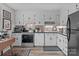 Efficient kitchen featuring modern appliances, white cabinetry, and a functional layout for a convenient cooking experience at 1300 Larchmont Pl # 306, Salisbury, NC 28144