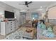 Cozy living room featuring a ceiling fan, plush seating, and a patterned area rug creating a warm and inviting space at 1300 Larchmont Pl # 306, Salisbury, NC 28144