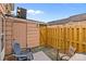 Outdoor patio with a wooden privacy fence and various chairs at 1300 Larchmont Pl # 306, Salisbury, NC 28144