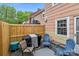 Outdoor patio featuring a wooden privacy fence, grill, chairs, and a small table on a painted deck at 1300 Larchmont Pl # 306, Salisbury, NC 28144