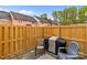 Outdoor patio featuring a wooden privacy fence, grill, chairs, and a striped rug at 1300 Larchmont Pl # 306, Salisbury, NC 28144
