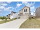 The exterior features a two-car garage, a stone and siding facade, and well-maintained landscaping at 330 Hyssop Ct, Fort Mill, SC 29715