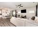 Open-concept living area with a large sectional sofa, dining table, and a view into the modern kitchen with white cabinets at 330 Hyssop Ct, Fort Mill, SC 29715