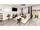 Bright living room with modern wood-look floors, a comfortable sectional sofa, and a sliding glass door to the backyard at 330 Hyssop Ct, Fort Mill, SC 29715