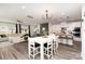 Bright, open living space featuring a modern kitchen, dining area, and living room with wood-look flooring and stylish decor at 330 Hyssop Ct, Fort Mill, SC 29715