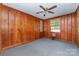Comfortable bedroom with wood-paneled walls, neutral carpet, and natural light from two windows at 3332 Celanese Rd, Rock Hill, SC 29732