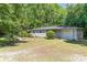 Lovely ranch style home showing a gravel driveway leading to an attached garage surrounded by mature shade trees at 3332 Celanese Rd, Rock Hill, SC 29732