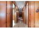 Long hallway lined with wood paneled walls offers access to multiple rooms at 3332 Celanese Rd, Rock Hill, SC 29732
