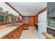 Wood-paneled kitchen offers plenty of counter space, classic appliances, and natural light from the large window at 3332 Celanese Rd, Rock Hill, SC 29732