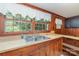Sunlit kitchen with abundant natural light, classic wooden cabinets, and a double sink under the window at 3332 Celanese Rd, Rock Hill, SC 29732