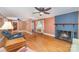 Cozy living room featuring a fireplace, ceiling fan and hardwood floors at 3332 Celanese Rd, Rock Hill, SC 29732