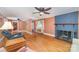 Cozy living room featuring a fireplace, ceiling fan and hardwood floors at 3332 Celanese Rd, Rock Hill, SC 29732