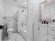 Bathroom featuring a bathtub-shower combination, marble wall tiles, and a white vanity at 3417 Chilham Pl, Charlotte, NC 28226