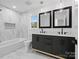 Bathroom featuring double vanity, tub, and marble flooring at 3417 Chilham Pl, Charlotte, NC 28226