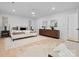 A bright main bedroom featuring hardwood floors and neutral decor at 3417 Chilham Pl, Charlotte, NC 28226