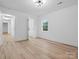 Bright room with hardwood floors and two doorways at 3417 Chilham Pl, Charlotte, NC 28226