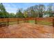 Wooden deck overlooking a well-maintained and spacious backyard and fence at 3417 Chilham Pl, Charlotte, NC 28226