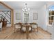 Bright dining room featuring modern lighting, neutral décor, and hardwood flooring at 3417 Chilham Pl, Charlotte, NC 28226